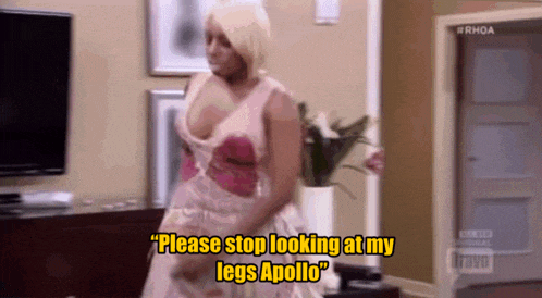a woman is standing in a living room and says " please stop looking at my legs apollo "