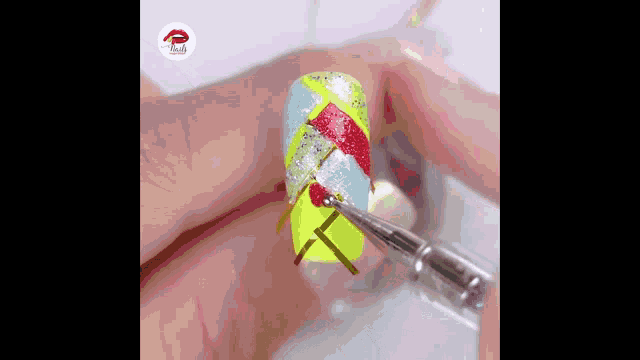 a person is applying nail polish to their nails with a nail polish brush .