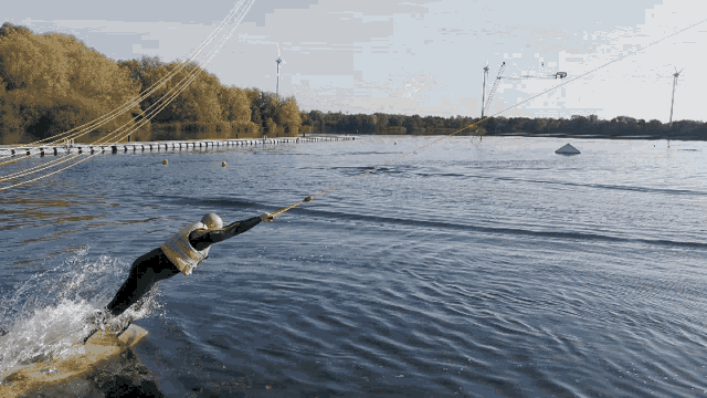 a person is riding a wakeboard in the water