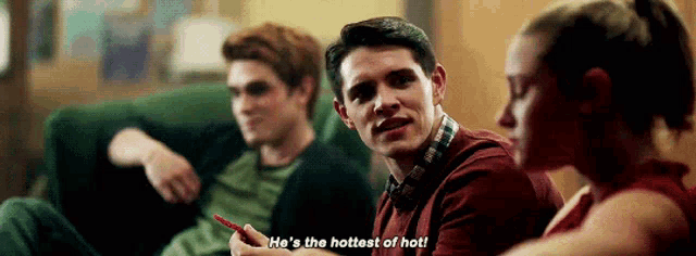 a group of people are sitting on a couch and one of them is saying he 's the hottest of hot !