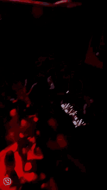 a group of people are dancing in a dark room with a sticker that says ' whatsapp ' on it