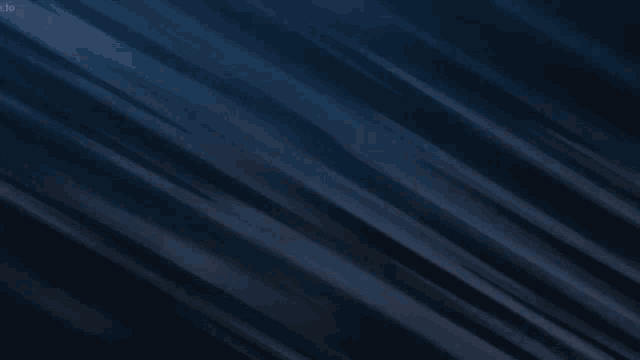 a man in a black cape is flying through a blue circle