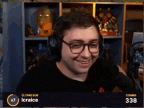a man wearing headphones and glasses is smiling in front of a screen that says icraice on it
