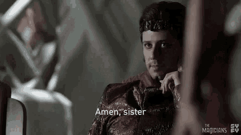 a man is sitting in a chair and talking on a cell phone while wearing a crown .