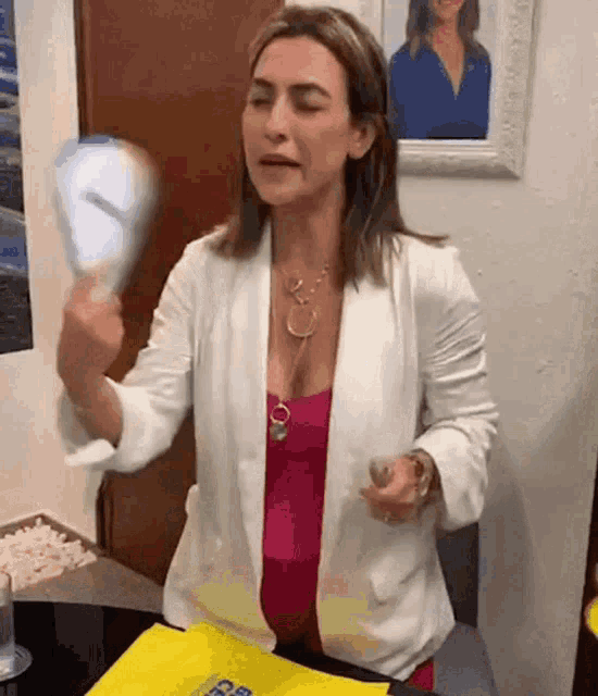 a woman is looking at herself in a mirror .