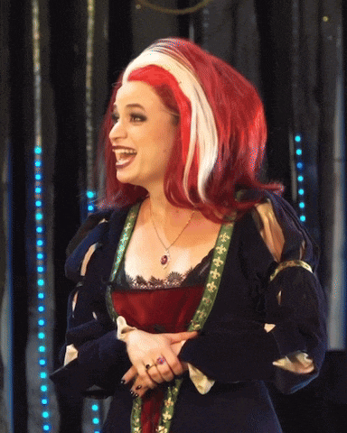 a woman with red and white hair is wearing a necklace