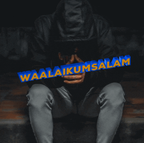 a man is holding a blue sign that says waalaikussalam