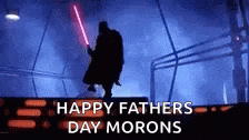 a silhouette of darth vader holding a light saber in a dark room .