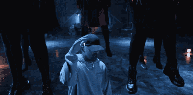 a person covering their face with their hands in front of a crowd