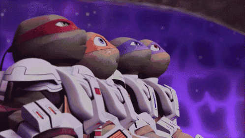 a group of teenage mutant ninja turtles are standing in a row