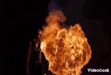 a man is smoking a cigarette in front of a flame that says mtcllass