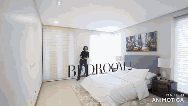 a woman stands in a bedroom with the words bedroom 2 on the bottom