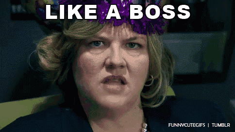 a woman wearing a purple party hat with the words like a boss written on it
