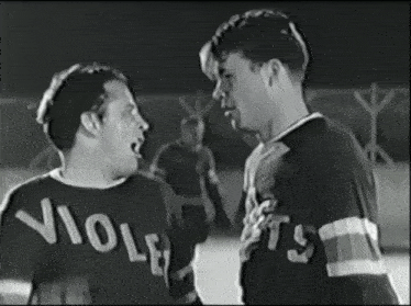two men are standing next to each other and one has a shirt that says violets on it