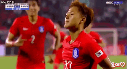 a soccer player in a red jersey with the number 2 on the front