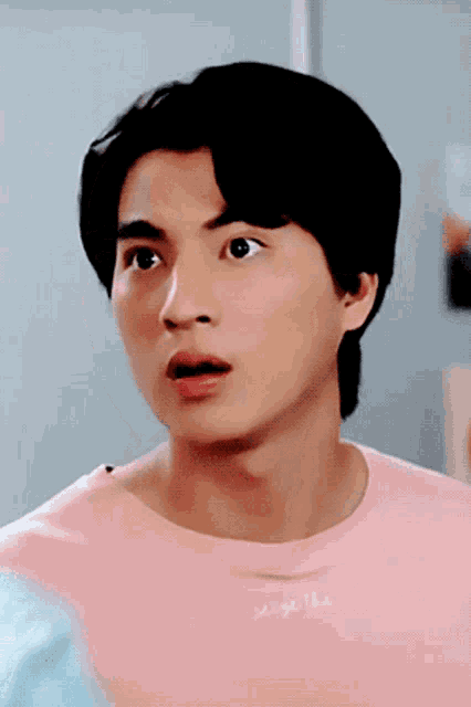 a man wearing a pink t-shirt that says make the on it