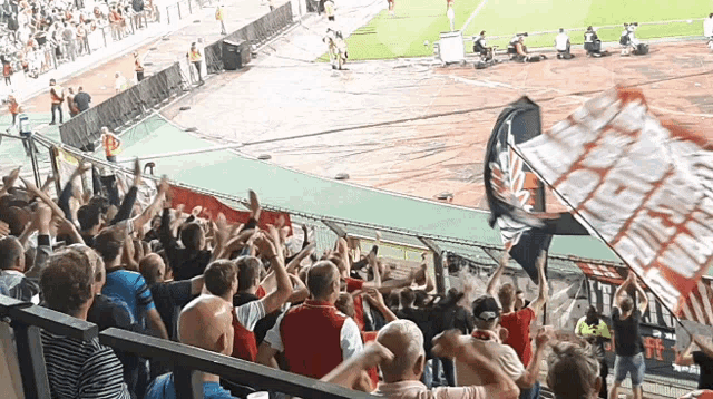 a crowd of people in a stadium with a banner that says ' fc '