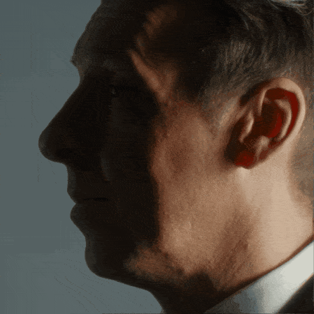 a close up of a man 's face with his ear visible