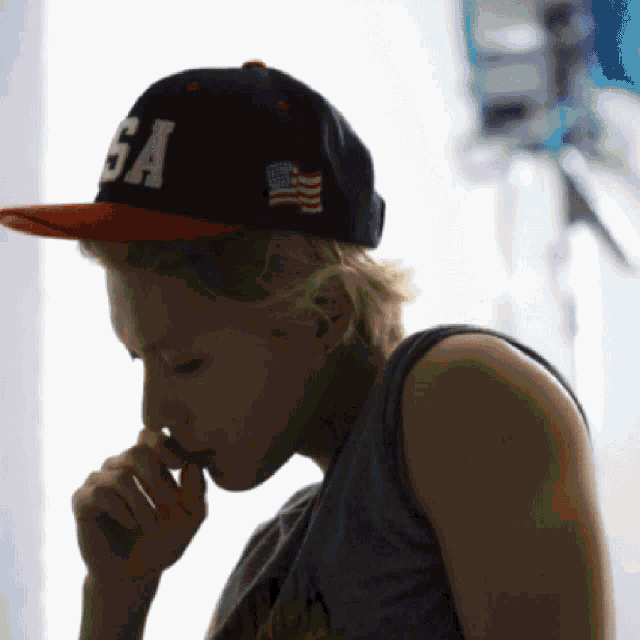 a woman wearing a black hat with the word sa on it