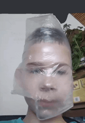 a boy with a plastic bag over his head