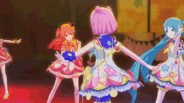 a group of anime girls are dancing together on a stage in a video game .