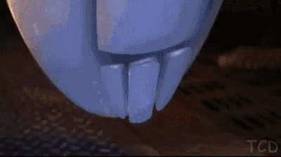 eve from wall e is standing in a dark room