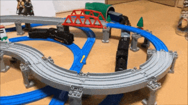 a toy train set with a bridge and a tunnel