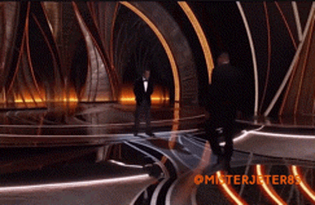 a man in a tuxedo walks across a stage with the hashtag misterjeter85 on the bottom
