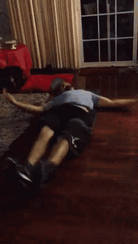 a man is laying on his back on the floor with his arms outstretched