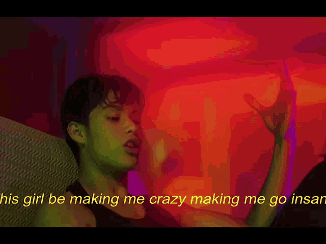 a man in a black tank top with the words his girl be making me crazy making me go insane on the bottom