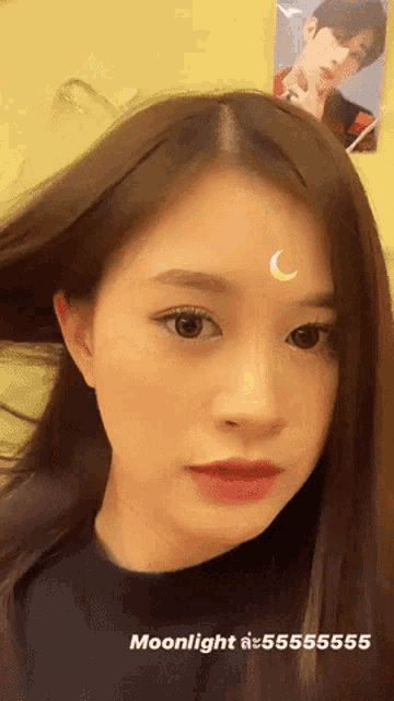a woman has a crescent moon on her forehead and the words moonlight written below her