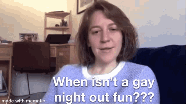 a woman in a purple sweater is sitting on a couch and talking to someone on a video call .
