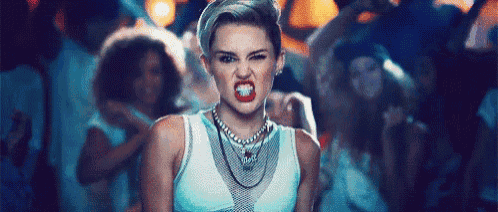 a woman is making a funny face in front of a crowd .