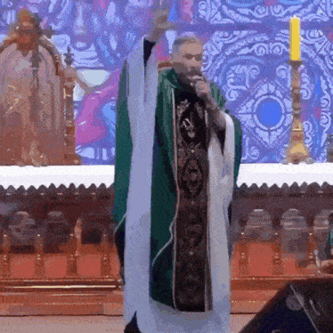 a priest stands in front of an altar with a candle