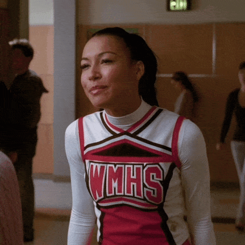 a cheerleader wearing a uniform that says wmhs on it