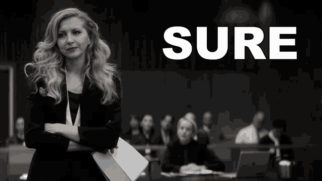 a woman in a suit stands in front of a group of people with the word sure behind her