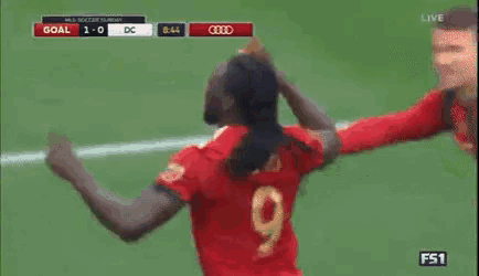 a soccer player with the number 9 on his back is celebrating a goal