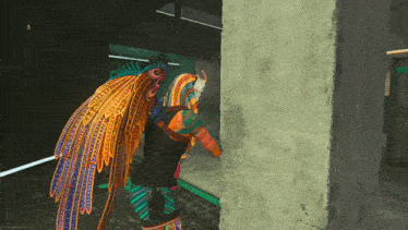 a person in a colorful outfit is standing next to a wall