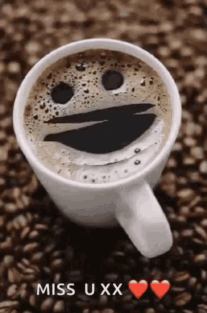 a cup of coffee with a smiley face made out of the foam