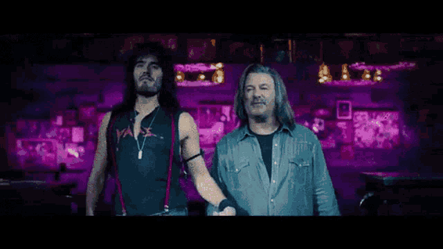 two men standing next to each other with one wearing a shirt that says ' axe '