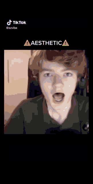 a man is making a funny face with his mouth open and a warning sign .
