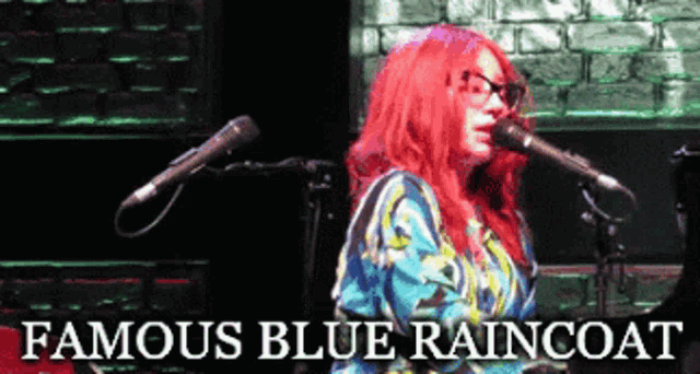 a woman with red hair singing into a microphone with the words famous blue raincoat above her
