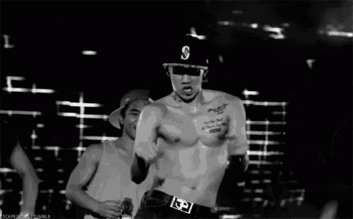 a man without a shirt is wearing a baseball cap with the letter s on it