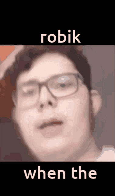 a close up of a man wearing glasses and a hat with the words robik when the written below him .