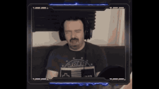 a man with a mustache is wearing headphones and a shirt that says classically on it .
