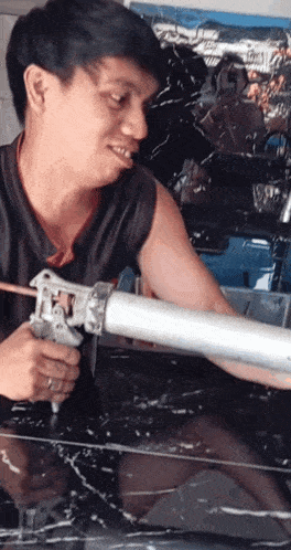 a man is holding a gun and smiling while using it