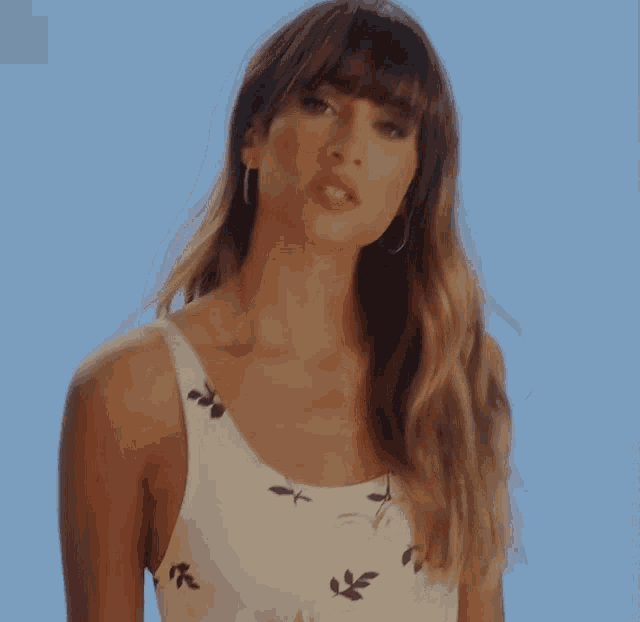 a woman in a white top with leaves on it