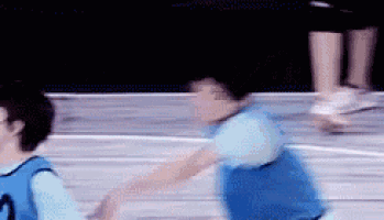 a blurry picture of a person playing basketball on a court .