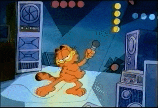a cartoon of garfield singing into a microphone in front of speakers