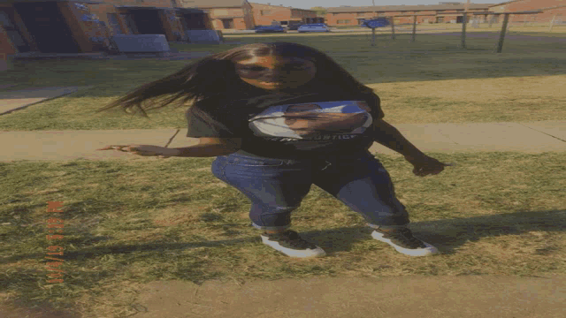 a girl wearing a t-shirt that says ' justice ' on it is standing on a sidewalk
